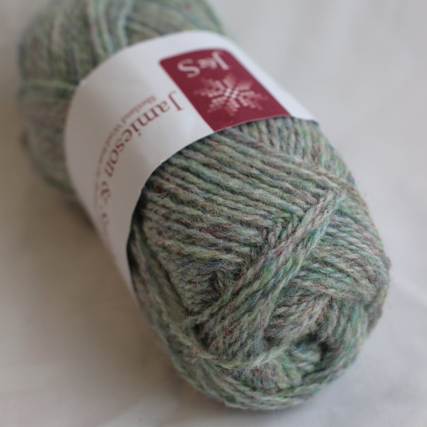 Ball of yarn with a label on a light background