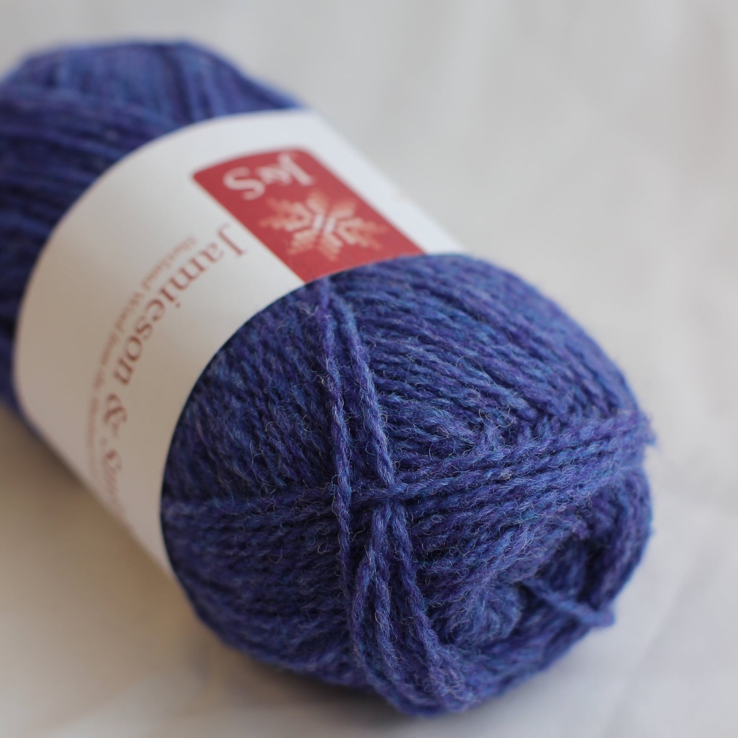 Blue skein of yarn with a label on a light background