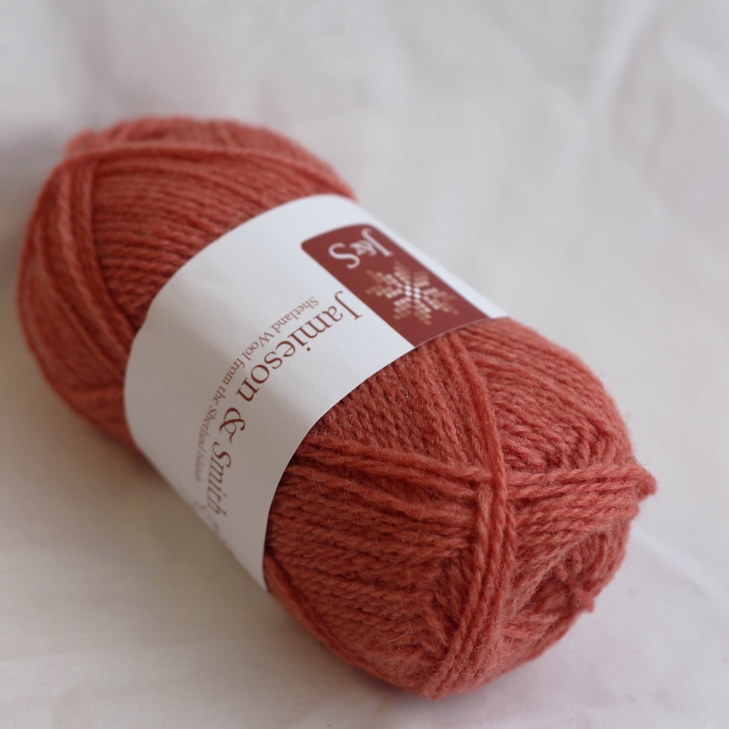 Ball of yarn with a label on a light background