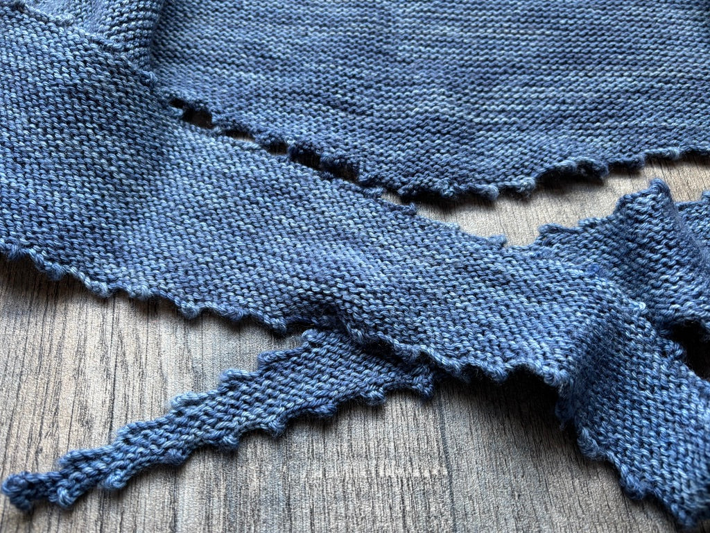 Single Skein Wrap - Pattern featuring a picot edged design, showcasing a delicate knit wrap on a wooden background.