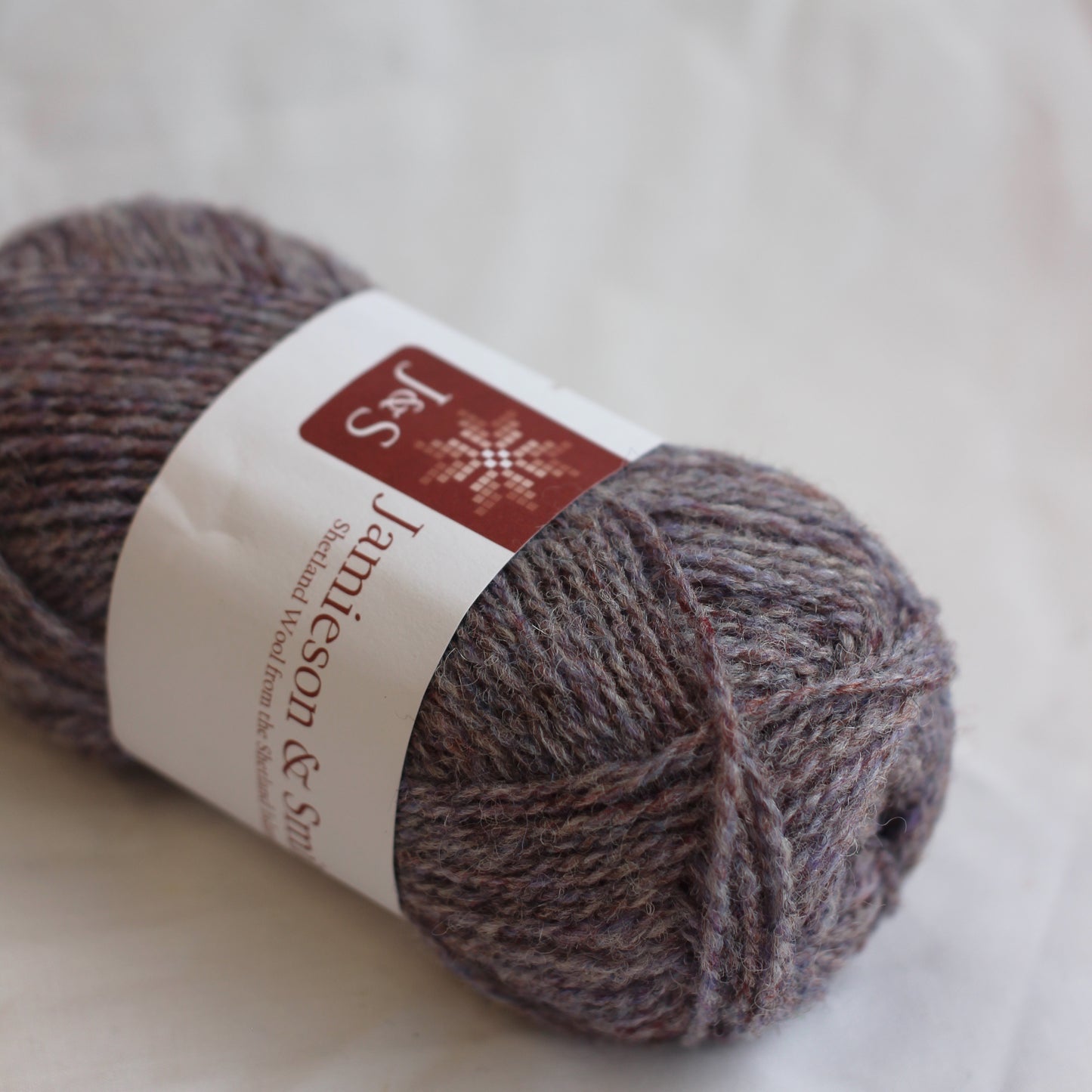 Ball of yarn with a label on a light background