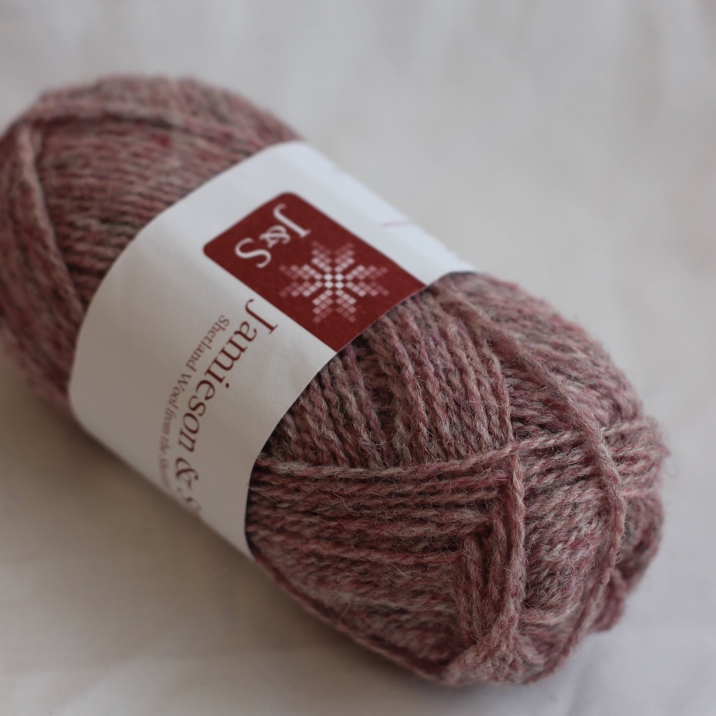 Ball of yarn with a label on a light background
